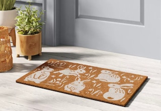 threshold spring bunnies coir doormat sitting outside a door
