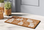 threshold spring bunnies coir doormat sitting outside a door