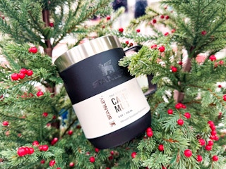 stanley mug sitting on a holiday wreath at target