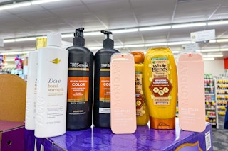 dove, tresemme, monday, and garnier shampoo and conditioners on a shelf