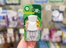 hand holding air wick scented oil warmer