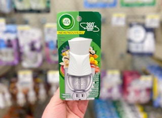 hand holding air wick scented oil warmer