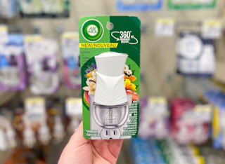 hand holding an air wick warmer in walgreens