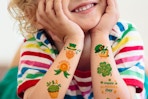 a boy wearing temporary tattoos