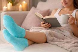 a woman putting on gel socks