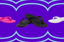 Three pairs of adult unisex Croc flip flops in pink, black and white