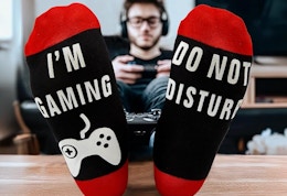 a person sitting with their feet up playing a video game