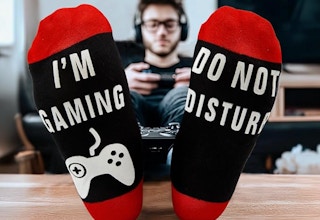 a person sitting with their feet up playing a video game