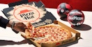 hand grabbing slice of pepperoni new yorker pizza hut near mini basketballs