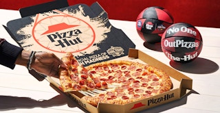 hand grabbing slice of pepperoni new yorker pizza hut near mini basketballs