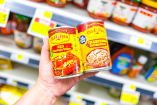 hand holding old el paso beans and enchilada sauce