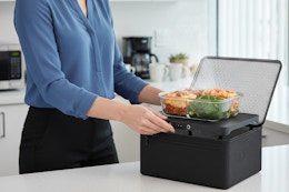 a woman using a heated lunch bag