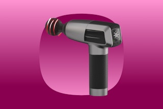 A black and grey massage gun with a spherical tip