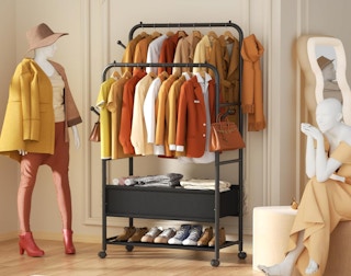 a rack of clothes and shoes in a room