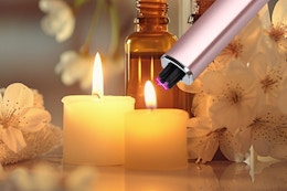 a candle lighter lighting small candles