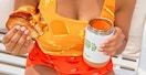 a person holding grilled cheese and soup from panera