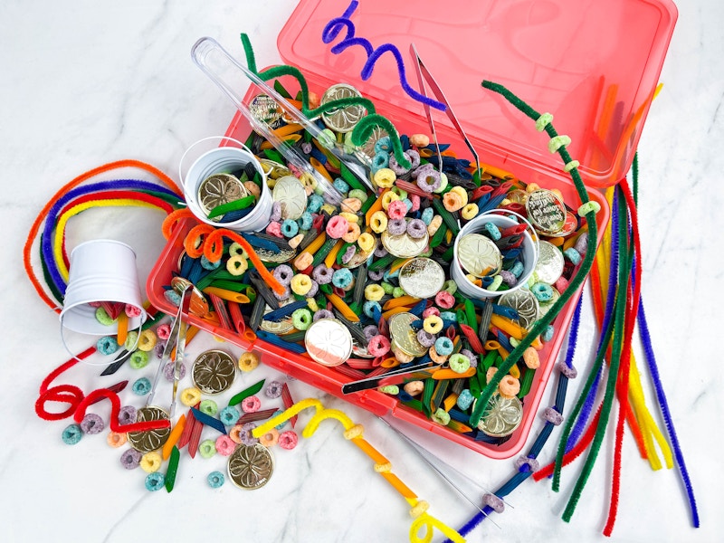 a diy rainbow themed sensory bin sitting on a counter