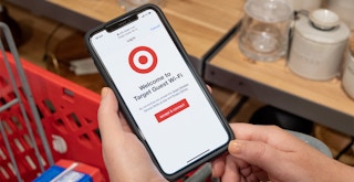 Someone holding a phone in Target displaying the Target Free Wifi page