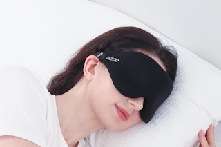 a woman using a sleep mask