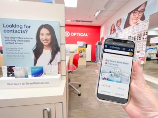 hand holding cellphone with walmart app comparing target contact lenses