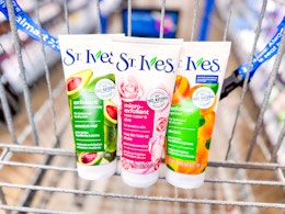 three bottles of St. Ives face scrub in a Walmart cart