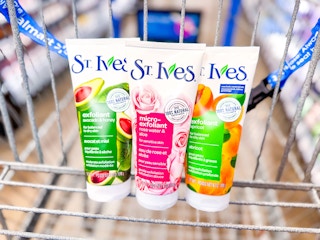 three bottles of St. Ives face scrub in a Walmart cart