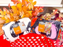 2 plush halloween blankets sitting on a cart