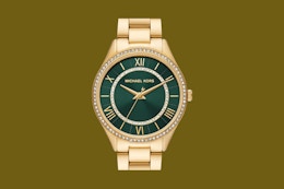 a woman wearing a michael kors watch