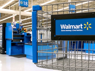 detail of walmart shopping cart near checkout area