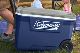 a man pulling a coleman 316 series twilight color cooler