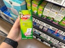 hand holding a bottle of childrens zyrtec in walmart aisle