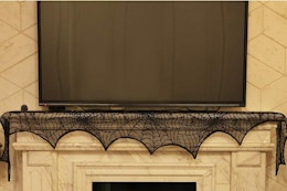 a spider web decoration under a TV