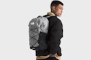 a man using a borealis grey laptop backpack from the north face