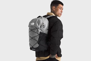 a man using a borealis grey laptop backpack from the north face
