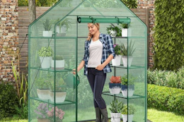 lifestyle image of a person standing in a greenhouse