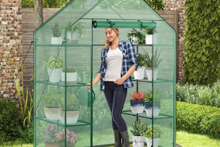 lifestyle image of a person standing in a greenhouse