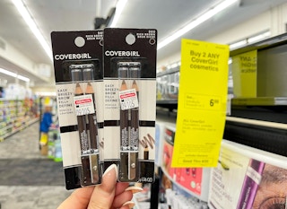 covergirl brow pencils held next to extrabucks sign