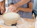 an electric sourdough starter with dough on a kitchen counter