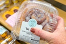 hand holding a kroger private selection cinnamon roll