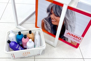 Ulta jumbo shampoos and conditioners in a basket in front of a sign