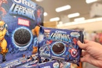 hand holding marvel legends oreos next to a display