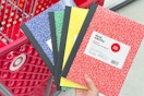 hand holding dealworthy notebooks in front of a target cart