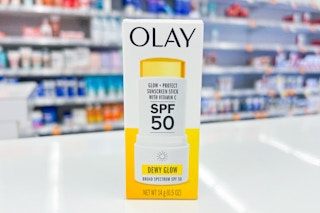 olay glow sunscreen stick on a white countertop in a store
