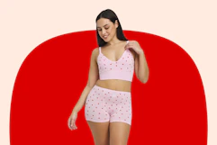 Woman wearing a strawberry printed bralette and pair of matching underwear