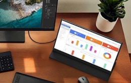 a laptop monitor on a desk connected to a computer