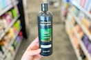 hand holding tresemme shampoo bottle