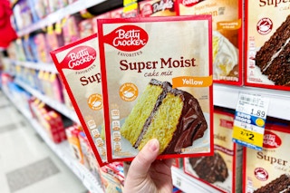 hand holding two boxes of betty crocker super moist cake mix