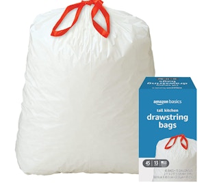 A full trash bag next to a box