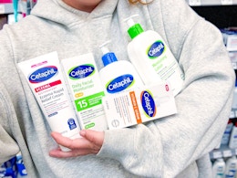 5 Cetaphil products being held by a person in Walmart store