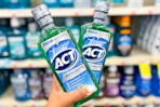 hand holding two bottles of act mouthwash